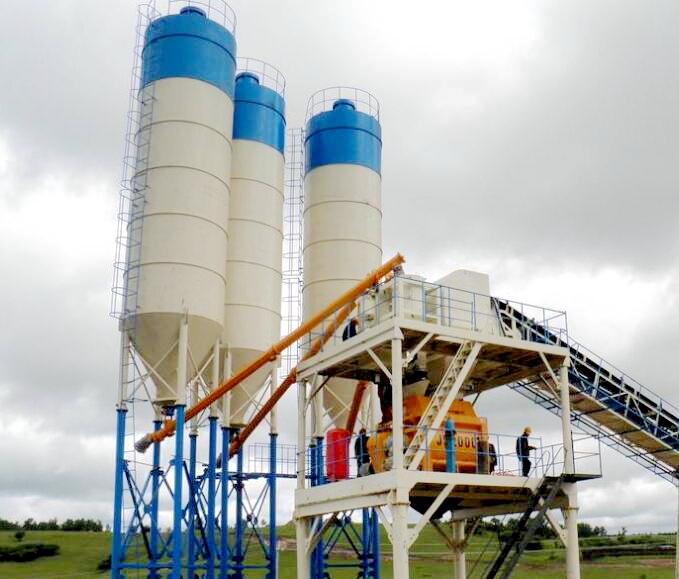 Inspector checking concrete batching plant components at factory before shipment